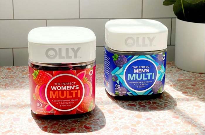 A bottle of women's and a bottle of men's Olly gummy multivitamins